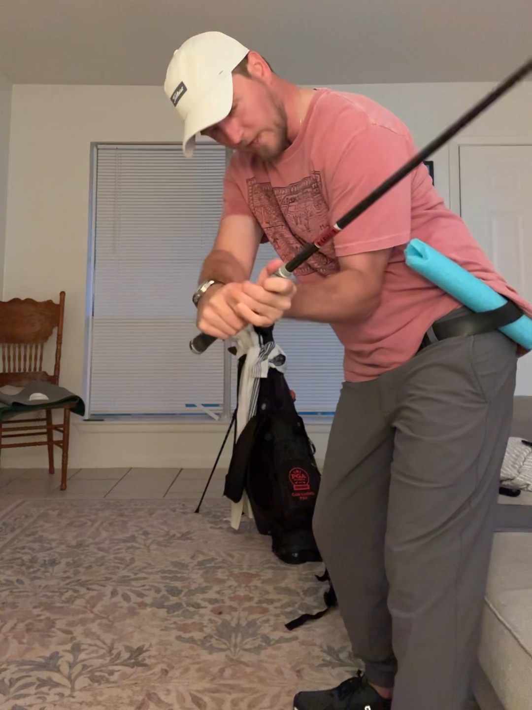Colin demonstrating a swing drill with a foam noodle tucked into his belt